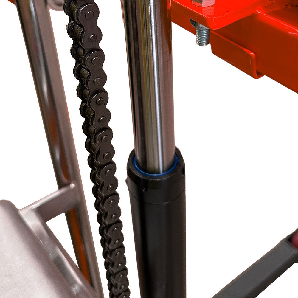 Close-up of a metallic chain alongside a shiny cylindrical rod and a black base, part of a mechanical device or equipment.