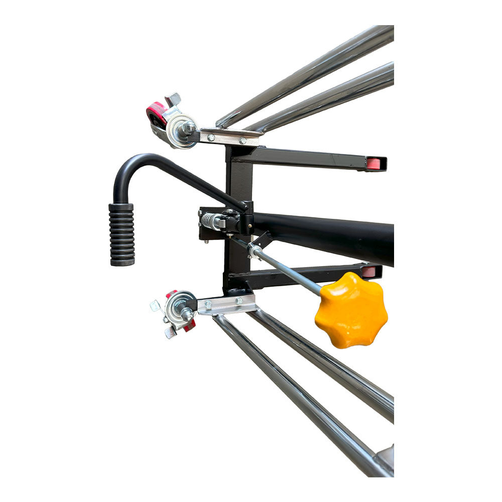 Close-up of a mechanical control handle with yellow knob and metal components, part of a larger industrial machinery setup.