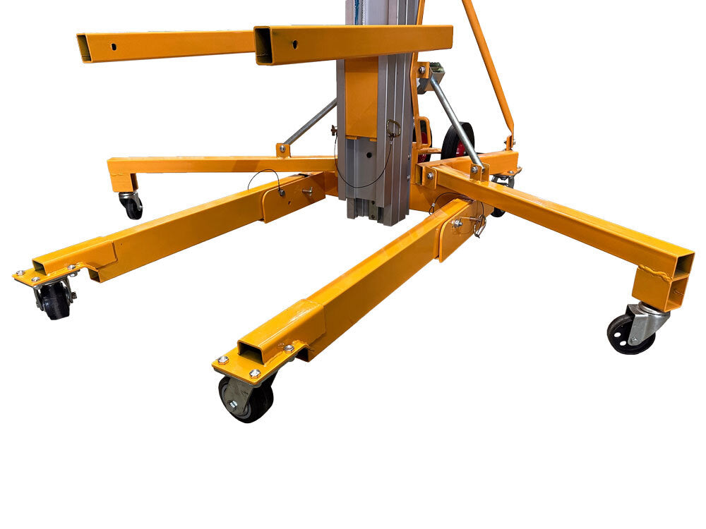 Close-up of a yellow hydraulic lift's base with four extendable arms and wheels for mobility on smooth surfaces.