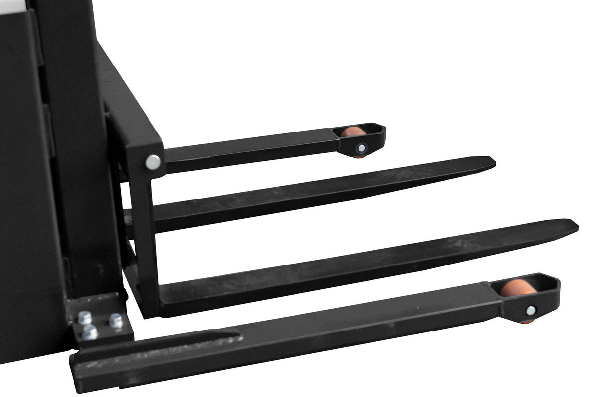 Close-up of a black pallet jack's forks, featuring cylindrical wheels at the tips and a sturdy, robust frame designed for lifting loads.