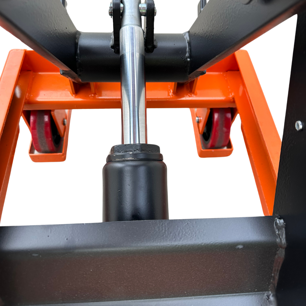 Close-up of a hydraulic lift's support structure, featuring a chrome hydraulic cylinder and orange wheels on a sturdy base.