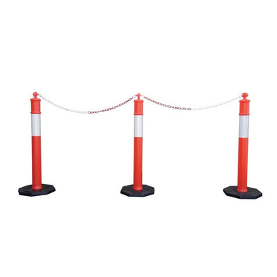 Three red and white traffic bollards connected by a chain, set on black octagonal bases, used for crowd control or road blocking.