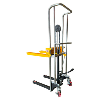 A manual hydraulic stacker with a sturdy frame, yellow lift arm, and four red swivel wheels, designed for moving and lifting heavy loads.