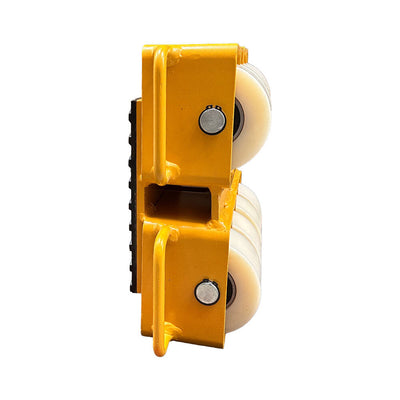 Close-up of a yellow roller block with two white wheels, designed for heavy lifting and material handling applications.