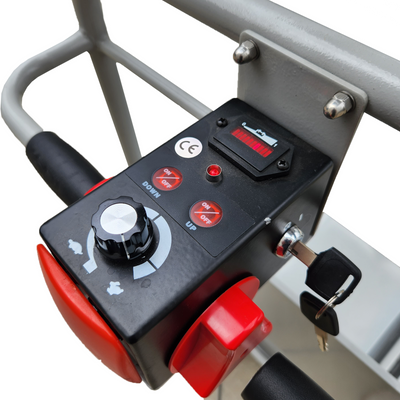 Control panel of a electric scissor lift featuring a key switch, up/down buttons, and a dial for speed adjustment.