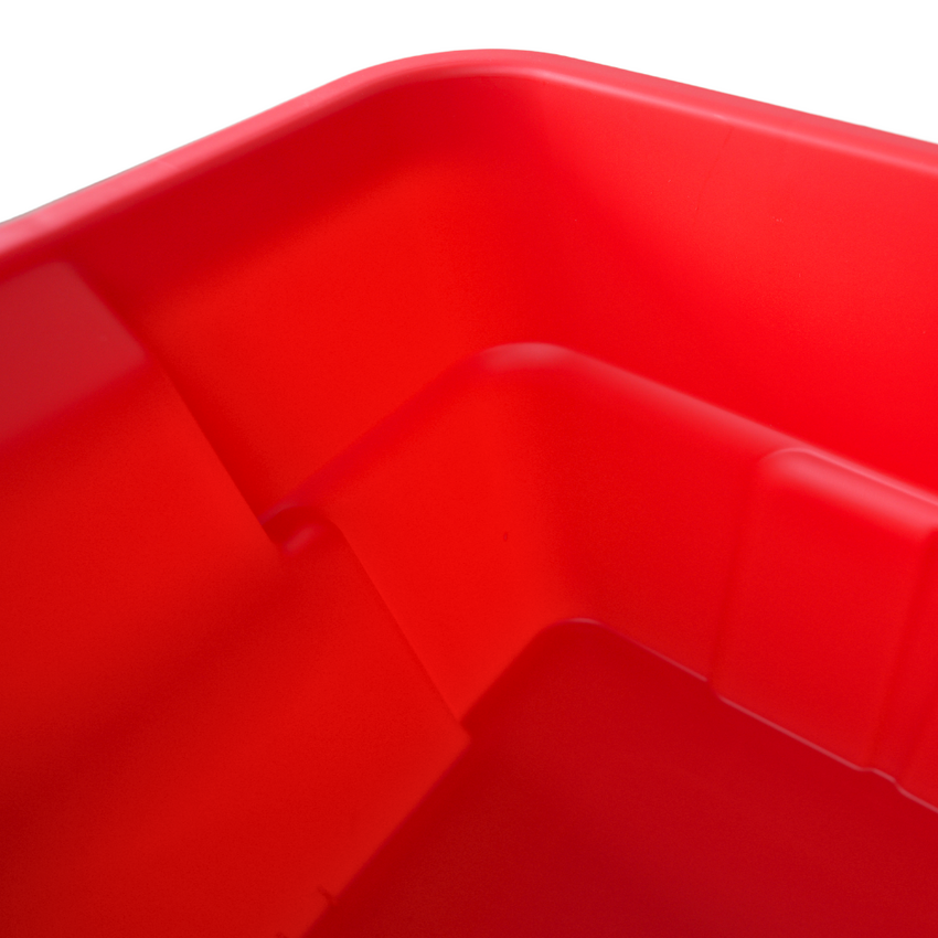 Close up of the inside corner of a red storage container showing the smooth rounded edge.