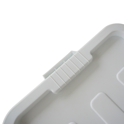 Close up of a white storage container ribbed lid design where the handle grip is located.