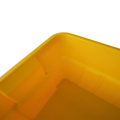 Close-up of a yellow plastic storage container, showcasing its smooth corners and bottom design with grid patterns.