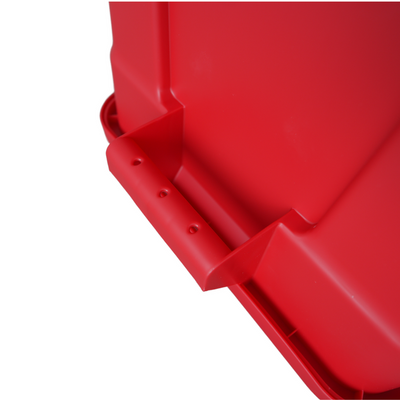 Close-up of a vibrant red plastic container, featuring a molded handle and smooth surfaces, ideal for storage or organising items.