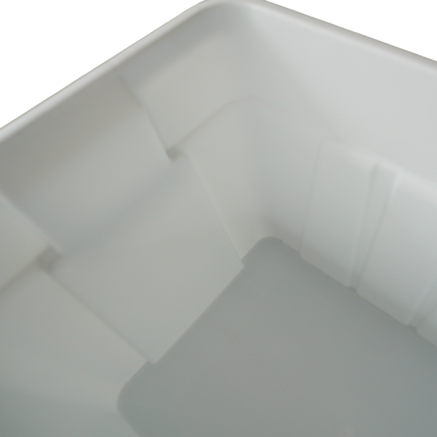 Close-up view of the interior of a smooth, white plastic storage bin with angled sides and a clean, empty base.