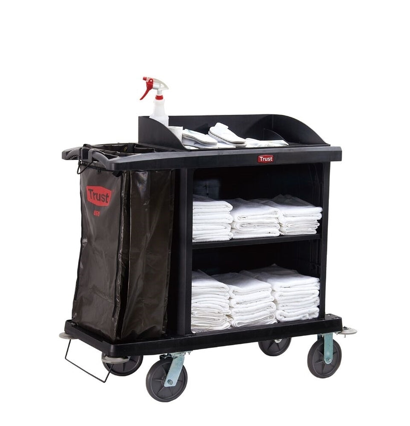Black housekeeping trolley with 4 wheels, a side bin bag, cleaning supplies on top, and white towels across two shelves.