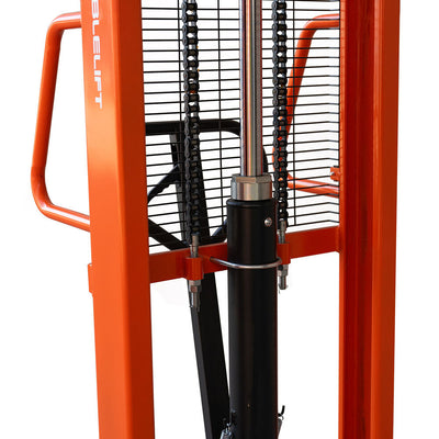 Close-up of a heavy-duty lifting machine with orange frame, hydraulic cylinder, and chain mechanisms, designed for lifting and moving loads.