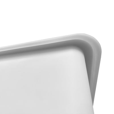 A close-up of a smooth white tub corner with rounded edges, highlighting its minimalist design.